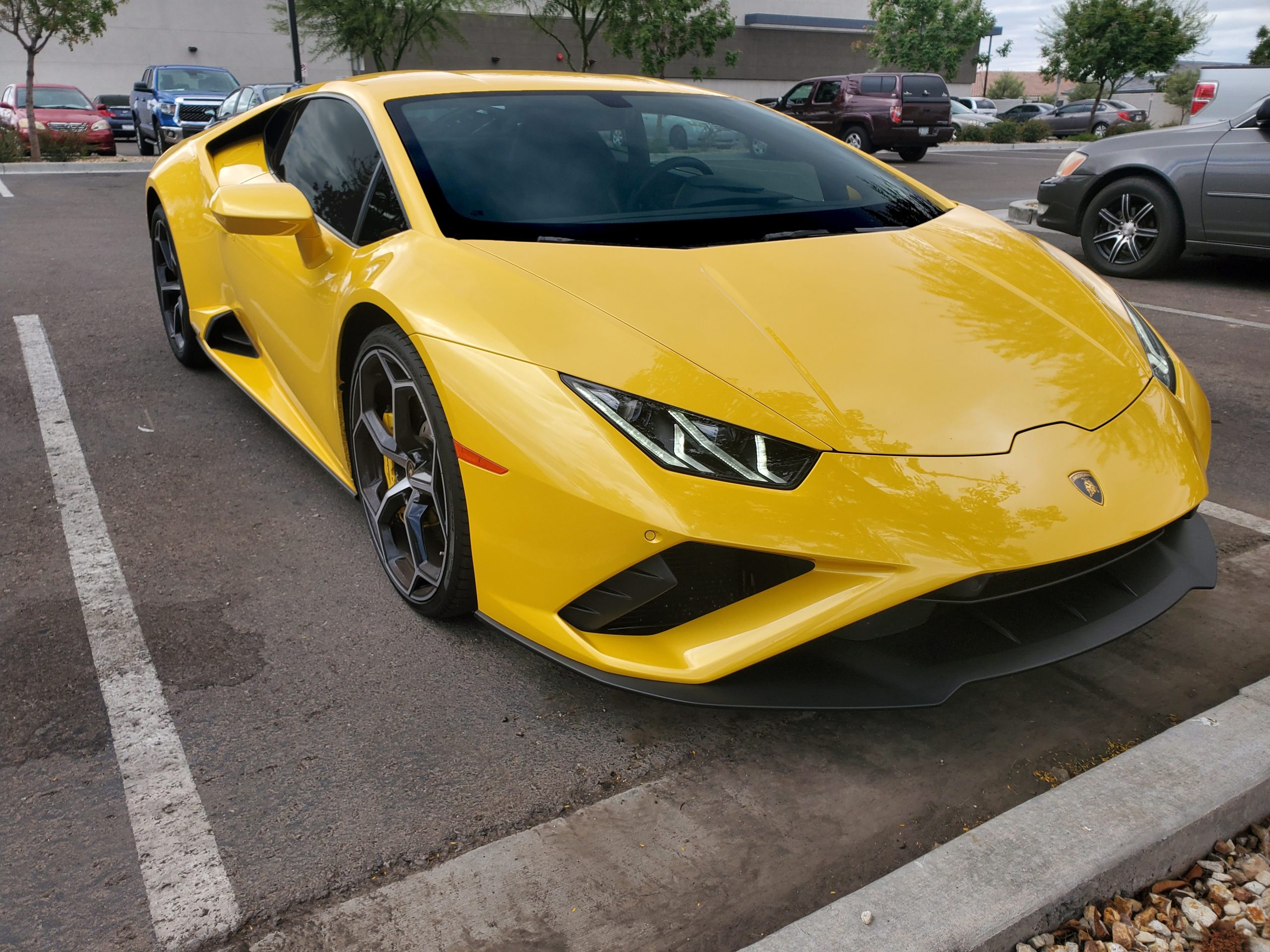 Yellow Lamborghini On A Parking Space With Tinted Windows